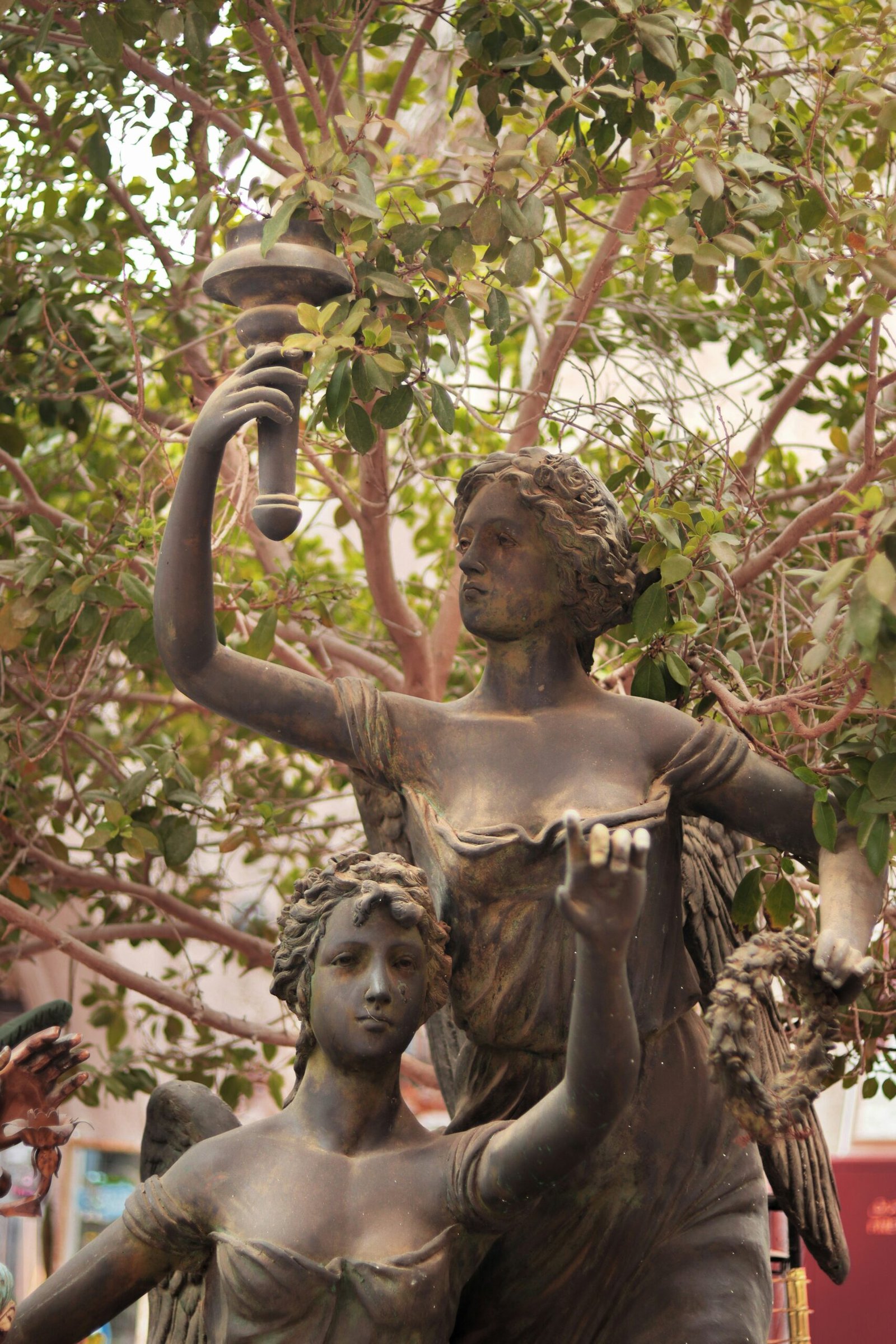 a statue of a woman holding a lamp